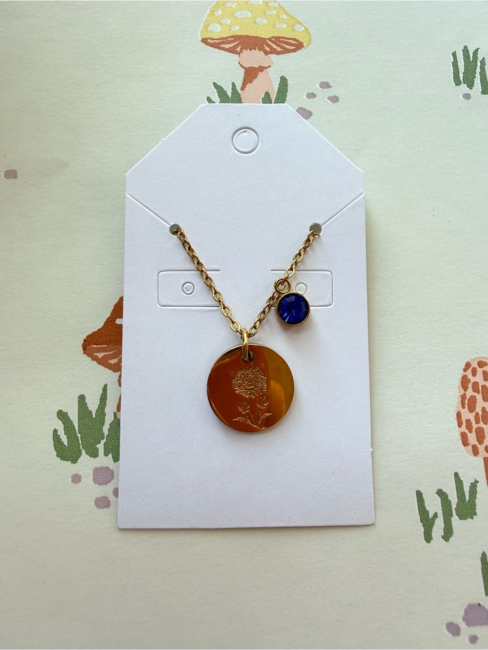 Gold-Tone Necklace with Gold Floral Disc and Blue Accent